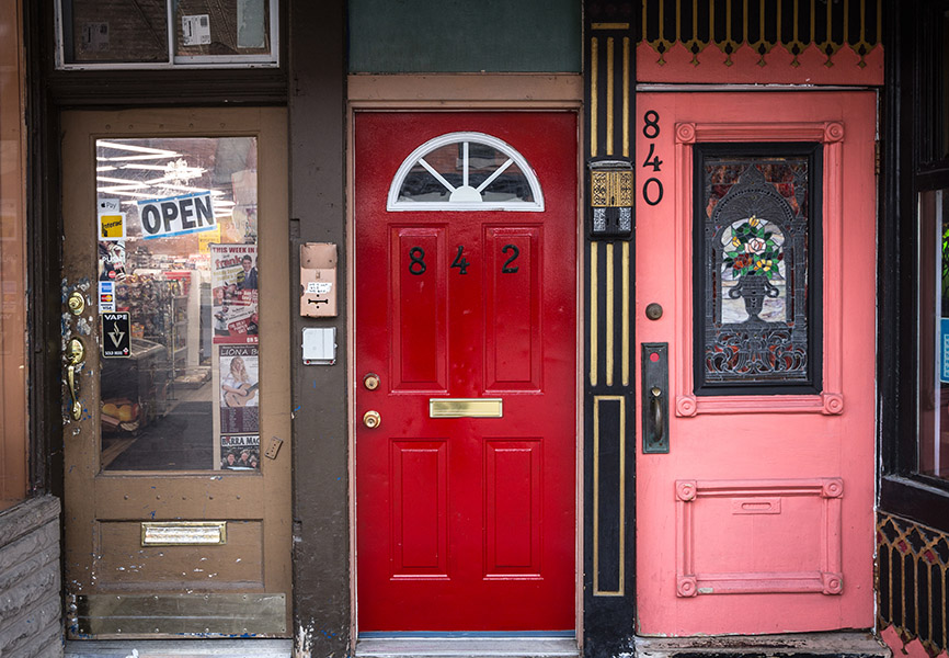 Brightly colour shop doors next to each other 